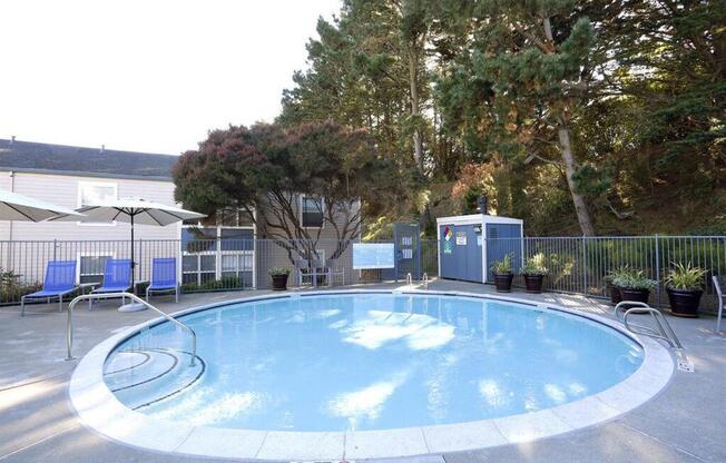 a swimming pool with chairs and a fence around it  at Skyline Heights LLC, Daly City, CA