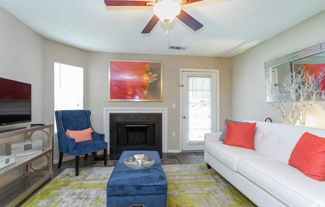 a living room with a couch and a chair and a fireplace