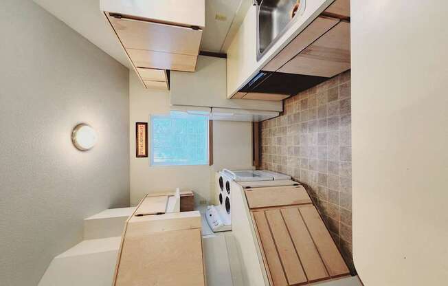 a kitchen with wooden cabinets and a stove and a sink