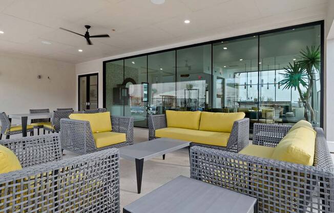 Living room with yellow sofa at  Reveal Skyline at La Cantera, San Antonio, TX