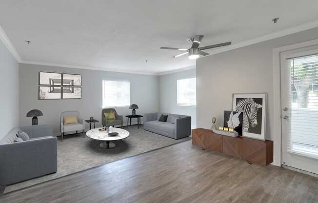 a living room with gray walls and a white ceiling fan