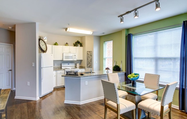 an open kitchen and dining room with a table and chairs at MetroPlace at Town Center, Maryland, 20746