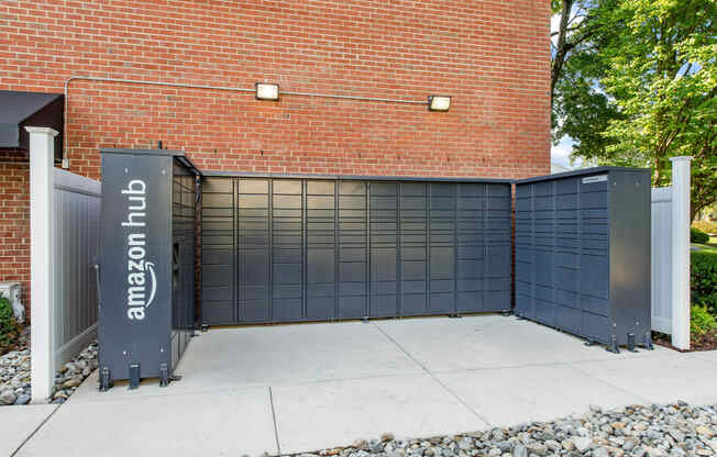 amazon hub package lockers in front of a brick building