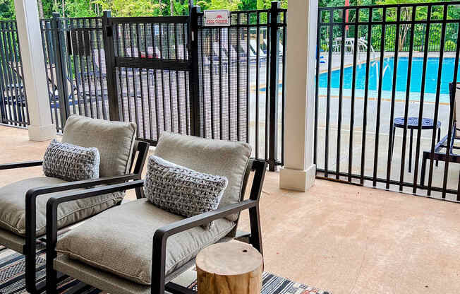 A black metal fence surrounds a pool.