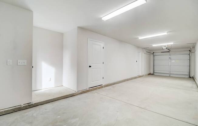 A white room with a door and a window.