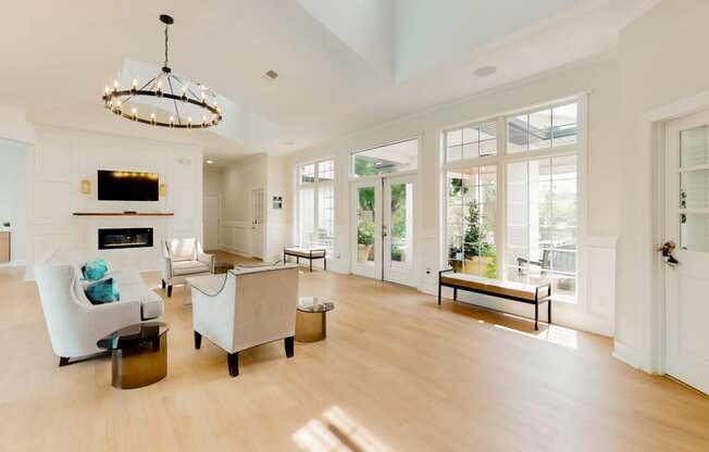 the living room has a fireplace and a large amount of windows
