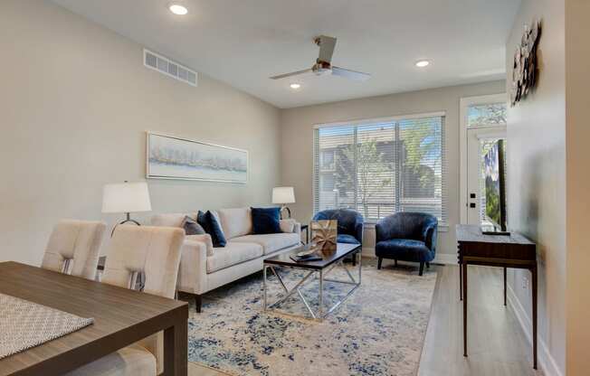 a living room with a couch and a table in  Maple Place Apartments - Southfield MI