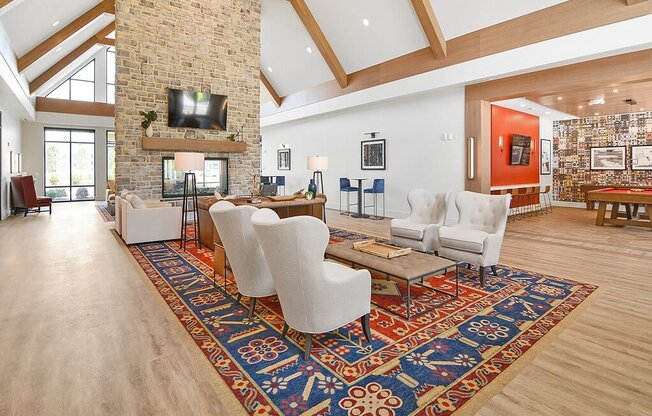 a large living room with a fireplace and a rug