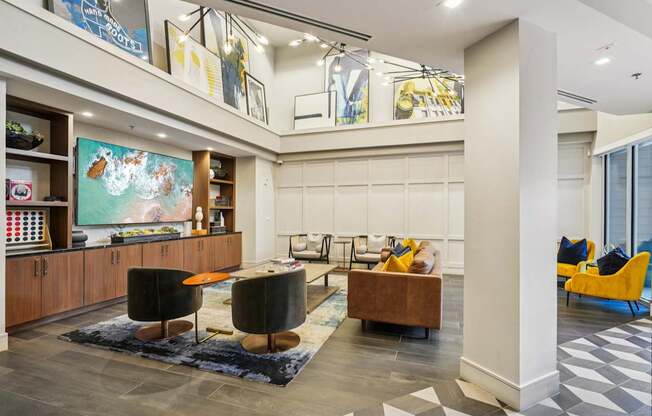 A living room with a blue rug and a yellow chair.