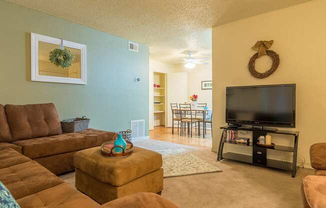 Somerpointe living room with plenty of couches and lounging space with carpet flooring