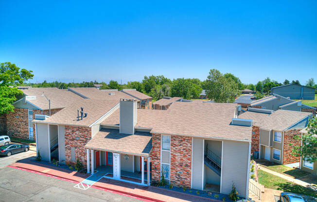 an aerial view of a building with cars parked in front of it