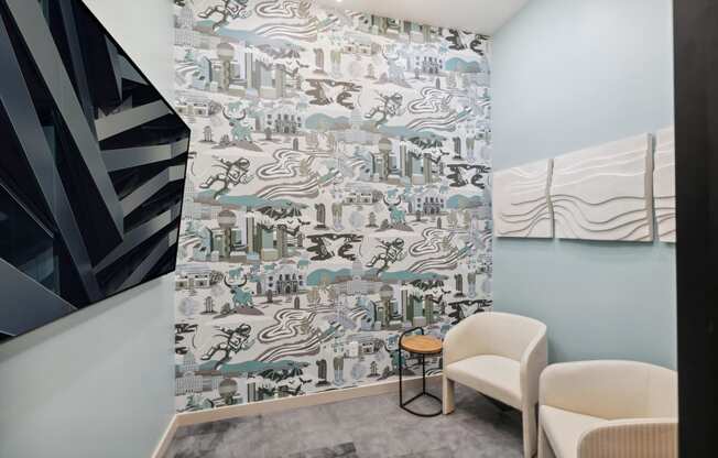 a room with two chairs and a wall with a mural of a city