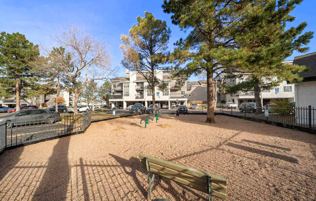 A park with a bench and a playground.