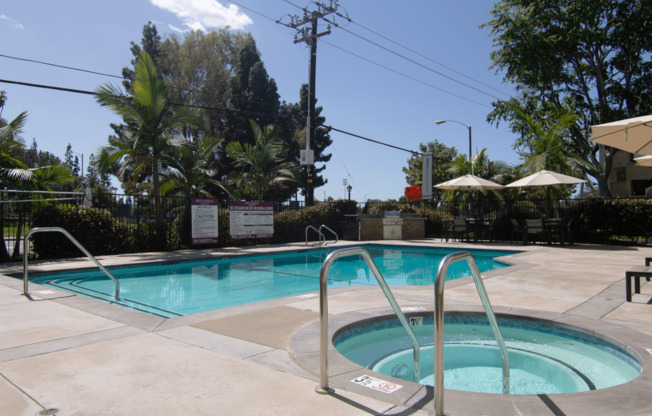 A small pool with a ladder and a diving board.