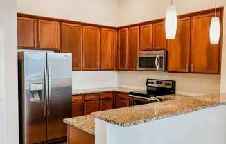 a kitchen with stainless steel appliances and a granite counter top