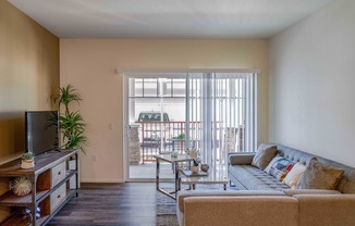 living room with wood like flooring and patio access at Turtle Creek apartments