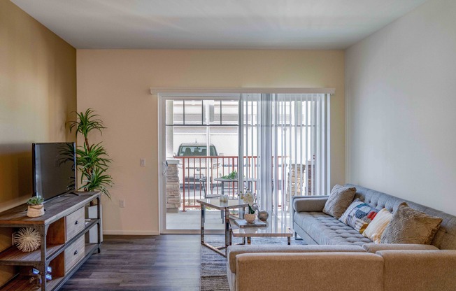 living room with wood like flooring and patio access at Turtle Creek apartments
