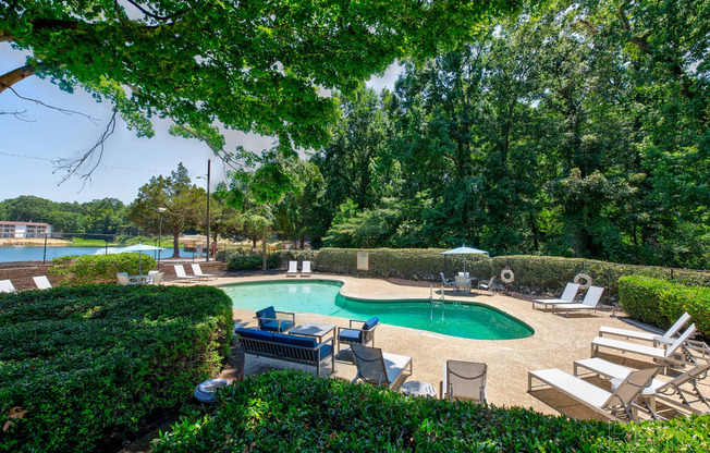 a pool with chairs and chairs around it and a swimming pool