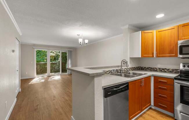 A kitchen with wooden cabinets and stainless steel appliances.