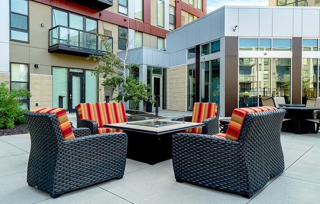 Patio seating surrounding a square fireplace table