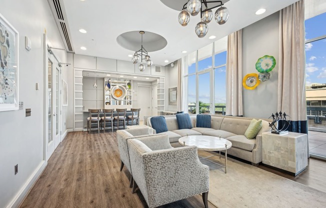 A living room with a grey sofa and a grey chair.