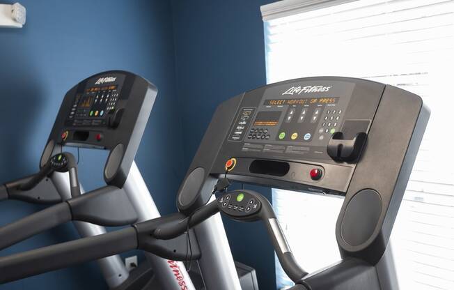 a close up of two treadmills in a gym