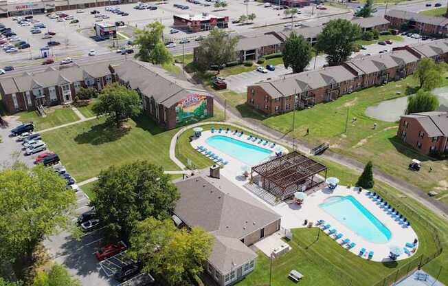 an aerial view of a pool and houses in a neighborhood