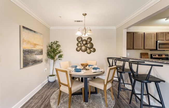 a dining room with a table and chairs and a kitchen