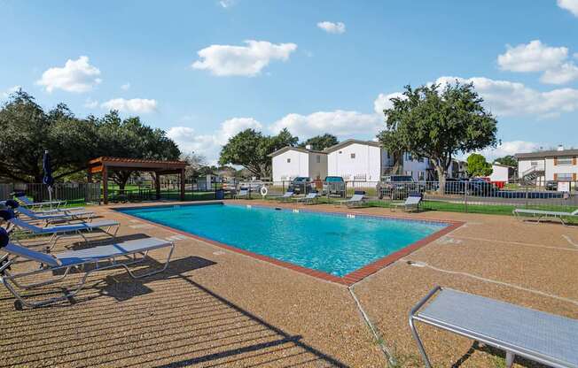 A pool with a red roof and a bench next to it.