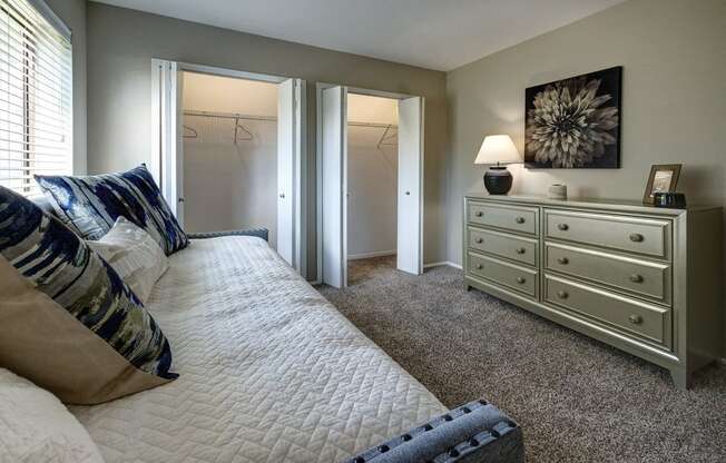 a bedroom with a large bed and a dresser