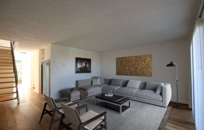 Living room setting with coffee table, couch and chairs at Villas at Harbor Pointe