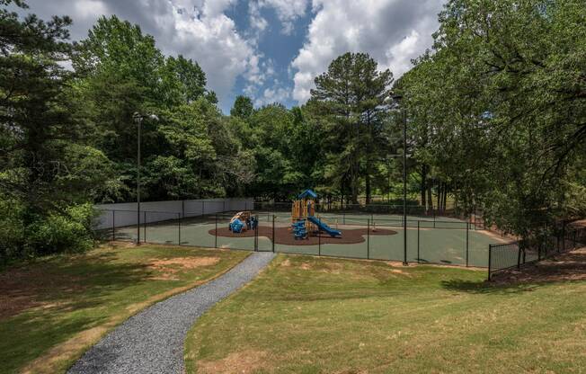 a tennis court with two kids playing on it