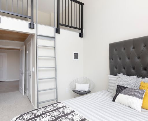 a bedroom with a bed and a lofted bed