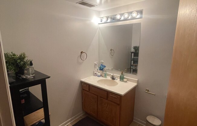 a small bathroom with a sink and a mirror