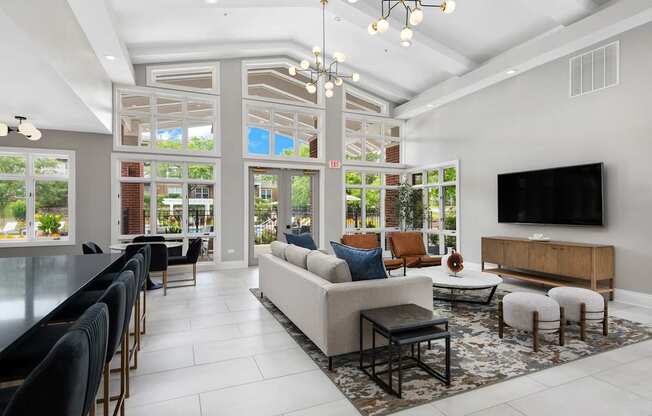 A modern living room with a large couch and a television.