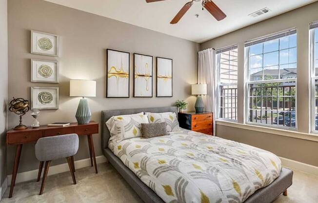 a bedroom with a bed and a ceiling fan