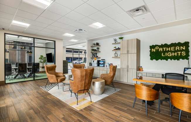 a lounge area with chairs and a table in a break room