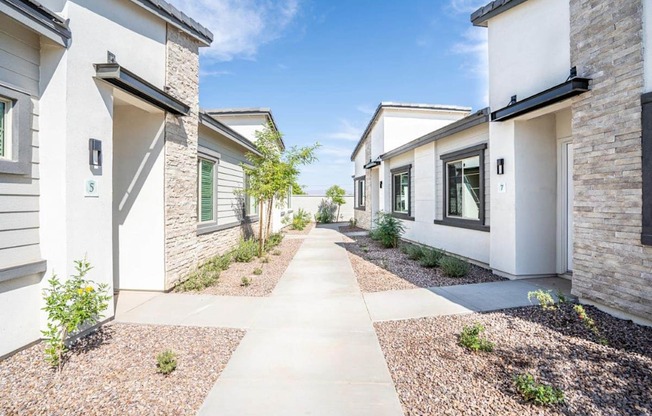 Landscaped walkways between the apartment homes at Village Greens of Queen Creek