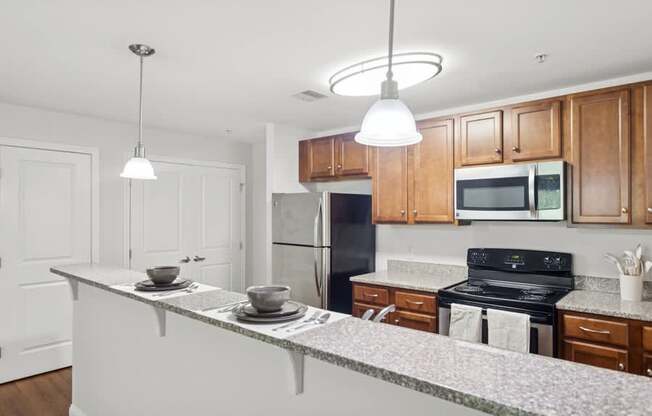 A kitchen with wooden cabinets and a black refrigerator.