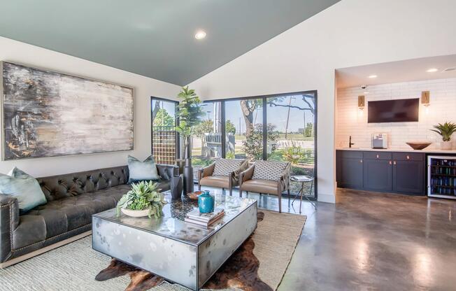 a living room filled with furniture and a large window