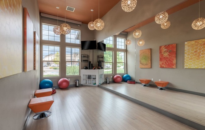 a yoga room with large windows and a wood floor