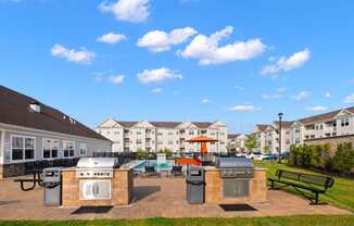 the preserve at ballantyne commons clubhouse with outdoor grills and a picnic table
