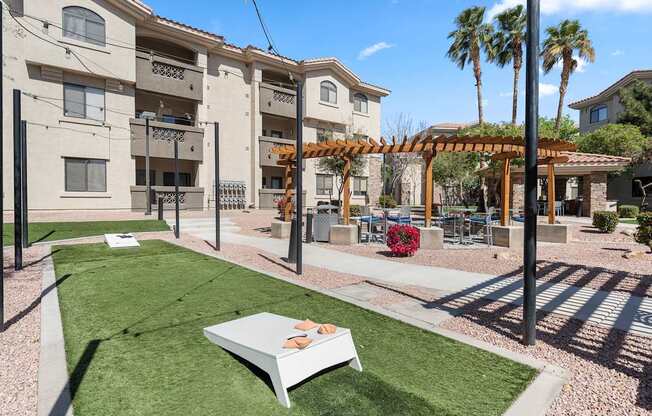 A white bench is in the middle of a grassy area.