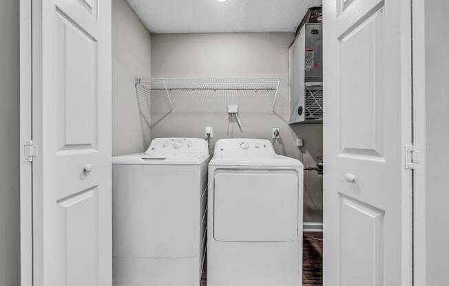a washer and dryer in a laundry room with white appliances