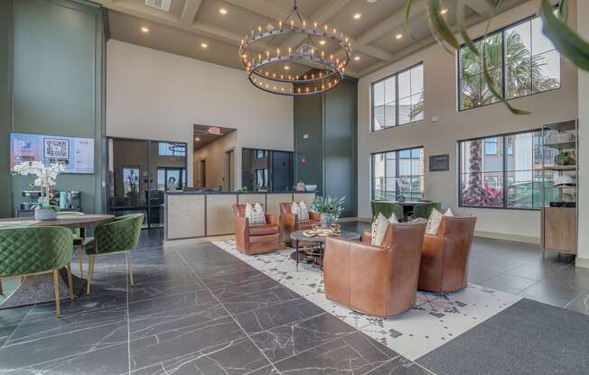 a lobby with chairs and tables and a large chandelier at Canter, Ocala, 34474