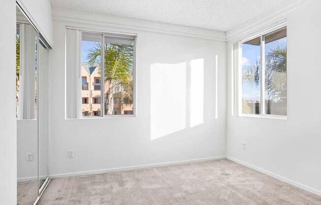 A room with a carpeted floor and a large window.