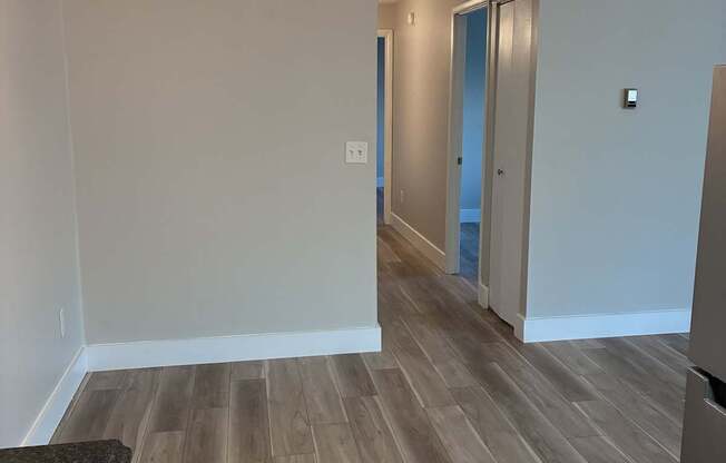 A room with a ceiling fan and light fixture.