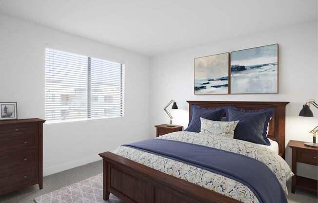 A bedroom with a large bed and two lamps.