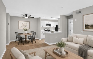 A living room with a dining table and chairs.