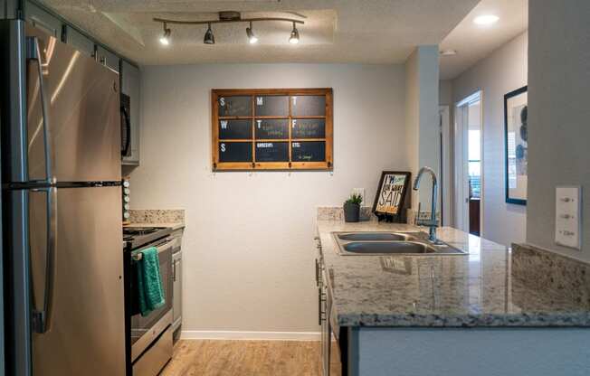 a kitchen with stainless steel appliances and a granite counter top